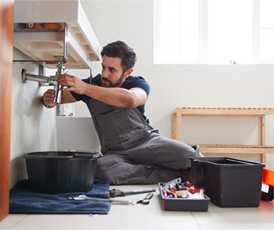 Plumber fixing clogged sink in Phoenix